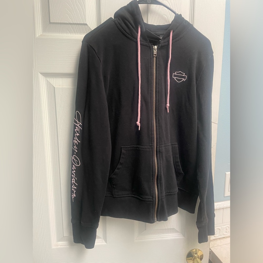 Harley Davison zip up in black with pink logos and draw strings. Size Medium.